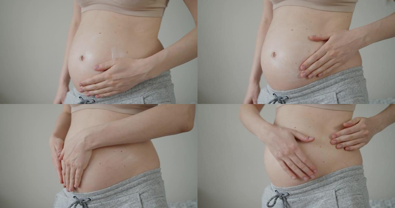 年轻孕妇在腹部涂抹妊娠纹按摩乳液