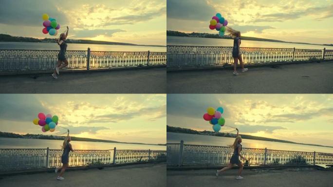 日落时湖边放着气球的开朗女孩。慢动作