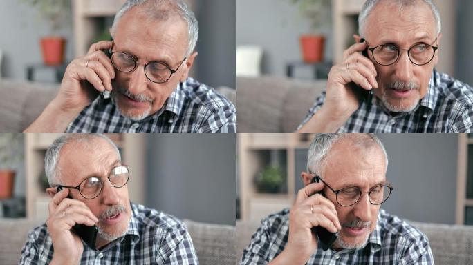 特写镜头面对70年代的老人正在说话的智能手机打电话给坐在家里沙发上的医生诊所