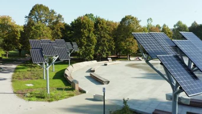 公园喷泉上一排排太阳能电池板，在阳光明媚的夏日，无人机可以看到太阳能发电厂的景色。