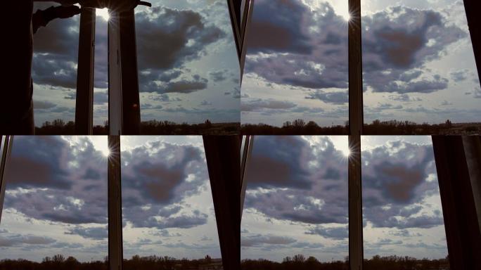 美丽的云彩透过窗户，阳光刺眼，从窗户到天空
