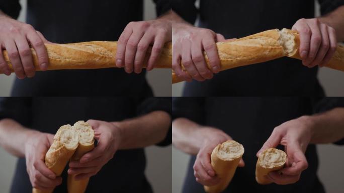 特写有机美味法式长棍面包在背景上的一个男人手中