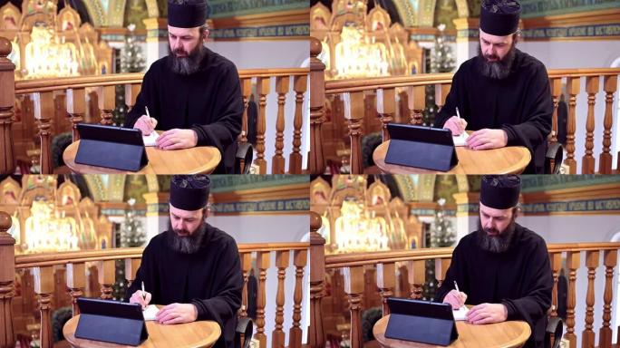 。一位东正教牧师正在为他的博客录制视频。在大流行期间传教。