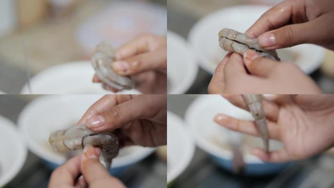 儿童在厨房里用手剥皮和去皮虾做饭前准备食物，生活方式的概念。