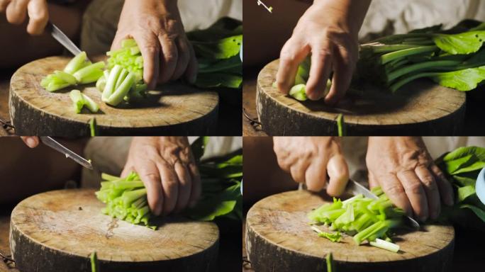 大白菜被老太太的手用刀切成薄片。准备烹饪泰国菜。亚洲食物菜单。白菜菜单。