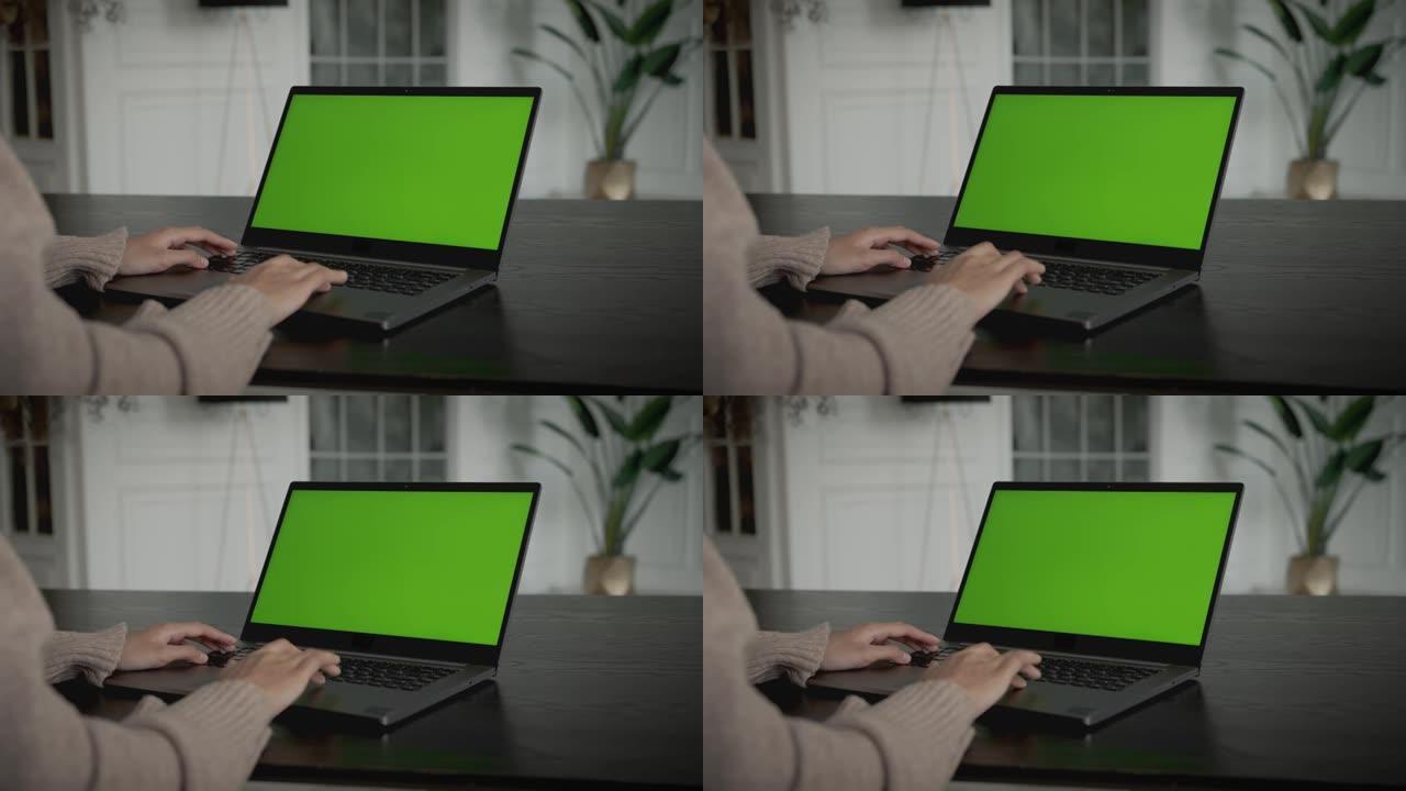 桌子上有笔记本电脑的女人，绿色的样机屏幕