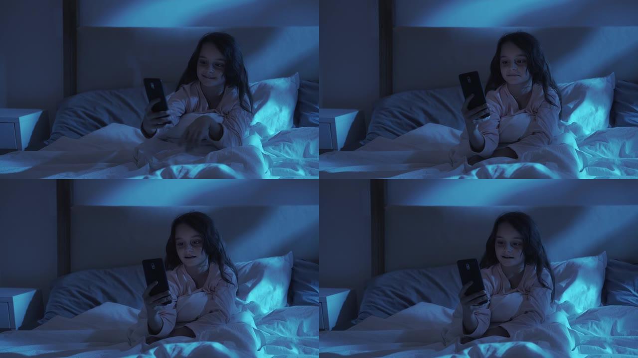 夜间视频通话儿童聊天女孩在床上使用电话