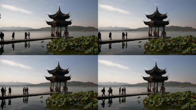 晴天时间杭州市著名的西湖拥挤码头海湾宝塔慢动作全景4k中国