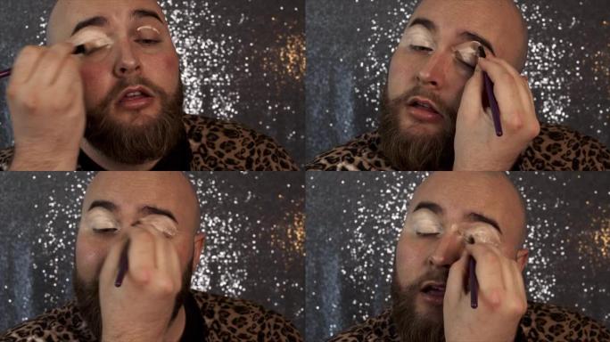 一名男性化妆师混合他的眼影底漆的4k视频片段
