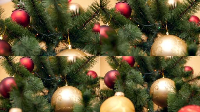 相机的特写4k平移视频缓慢地沿着装饰有小玩意，灯光和花环的圣诞树向下移动。为您的寒假和庆祝活动完美拍