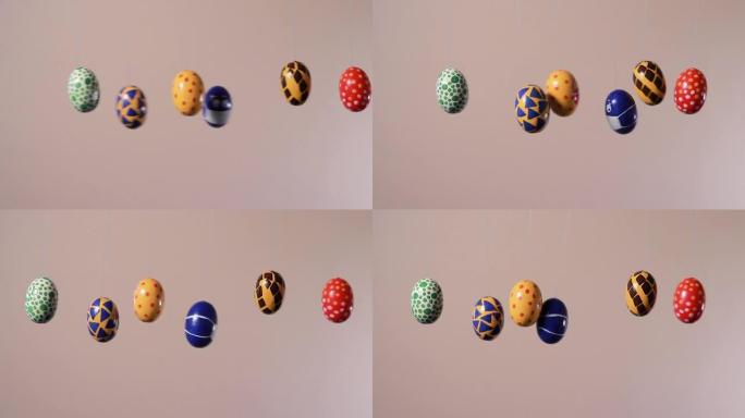 五颜六色的复活节彩蛋在脸上的面具中推动冠状病毒的彩蛋。复活节假期期间的covid大流行概念在医学和世