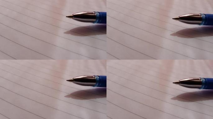 圆珠笔在阳光笔记本纸上排成一行