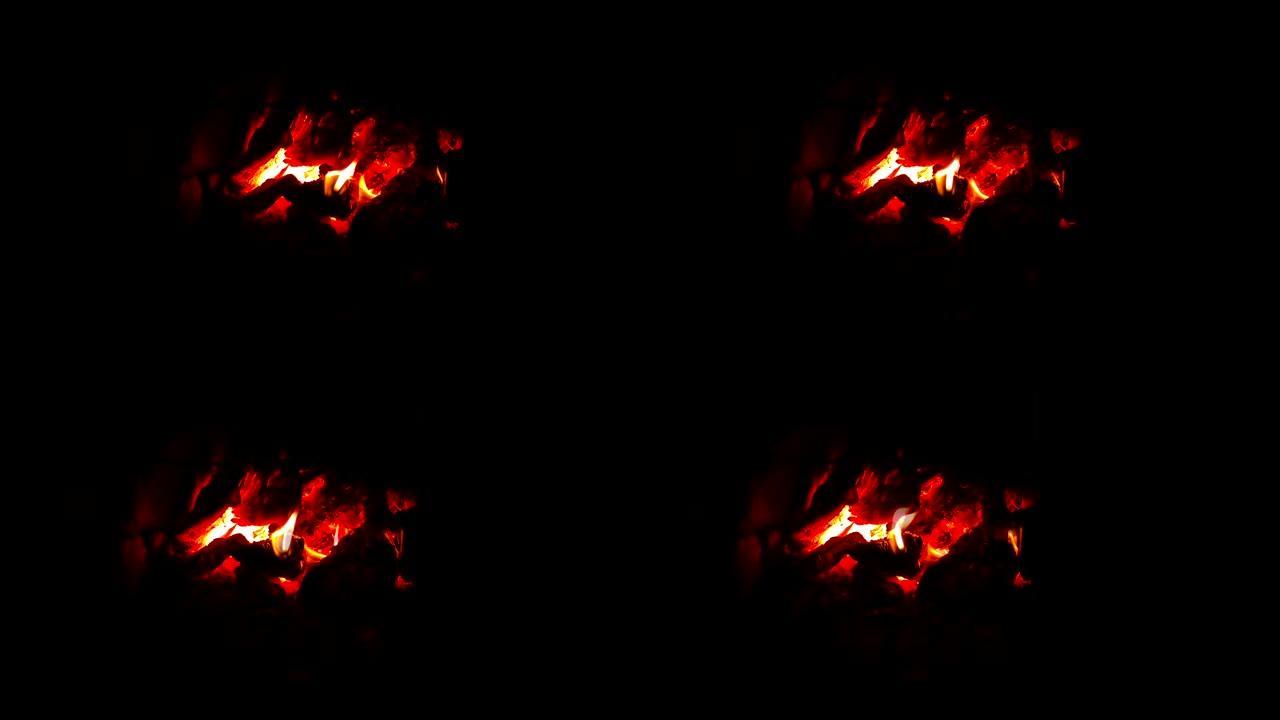 石炉里的柴火正在燃烧。烧焦的灰烬和煤