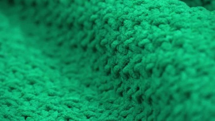 超级特写。绿色针织羊毛面料的细节。纺织背景。宏