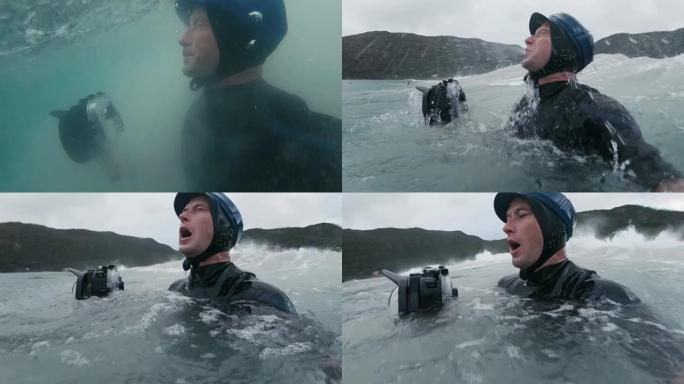 冲浪摄影师。戴着蓝帽子的人在经过强大的海浪后，带着动作相机从波涛汹涌的大海中出现