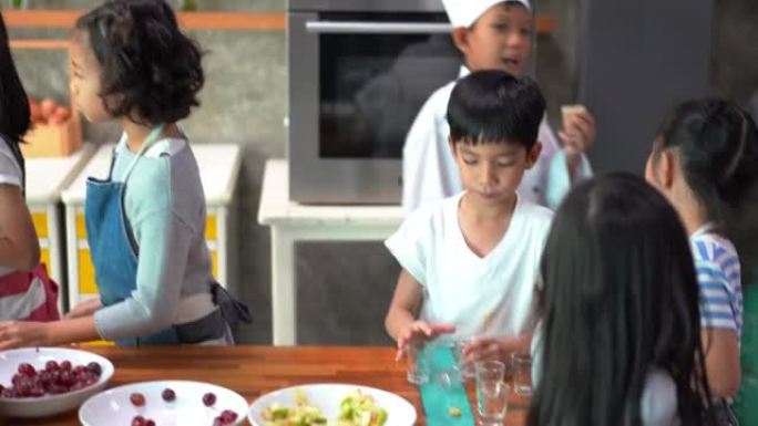 童年的学生和朋友在学校课堂上学习如何在厨房做饭