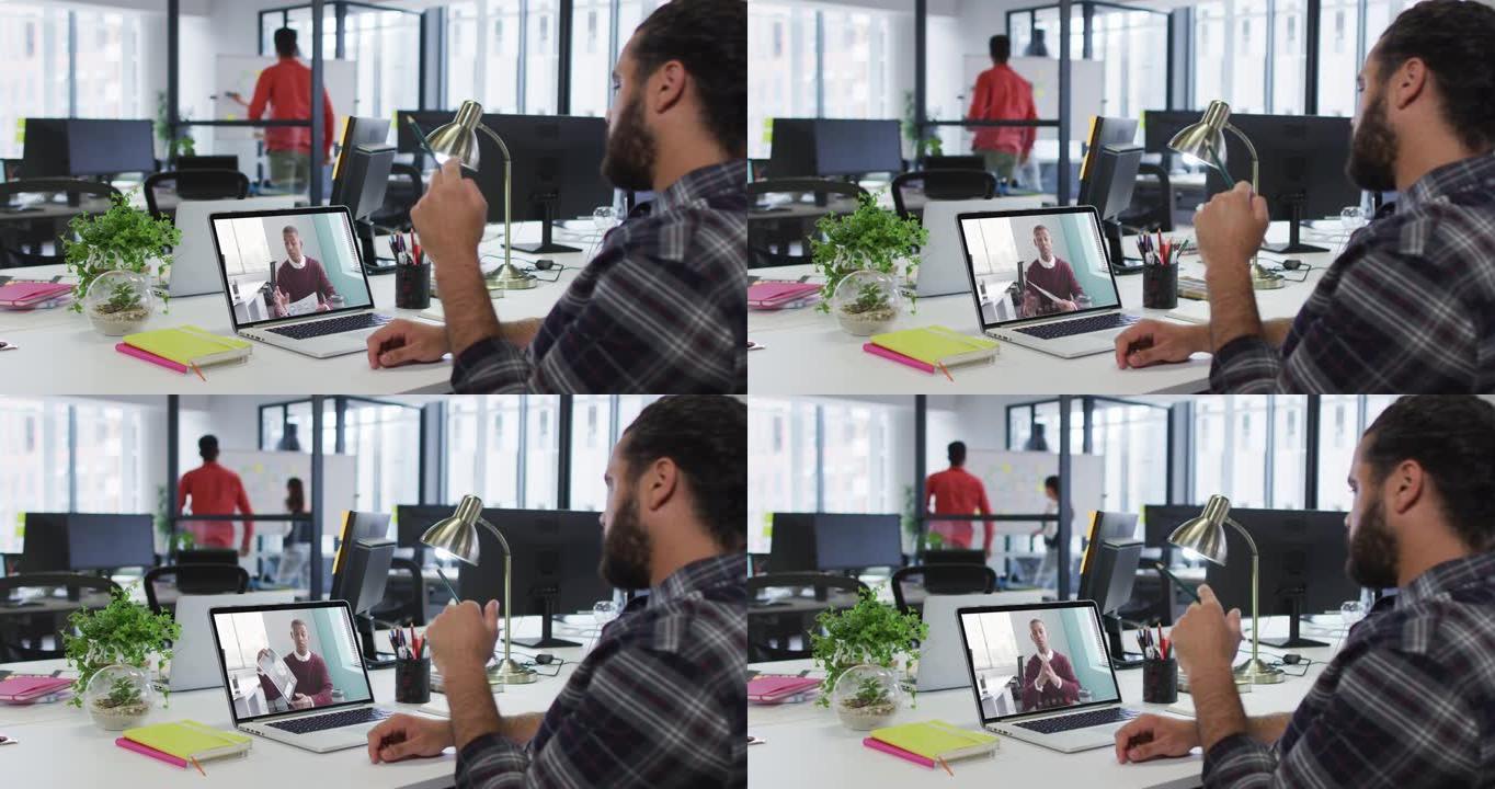 中东男子在办公室的笔记本电脑上与男同事进行视频通话