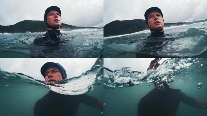 冲浪摄影师。戴着防护帽的男人环顾四周，在汹涌的大海中