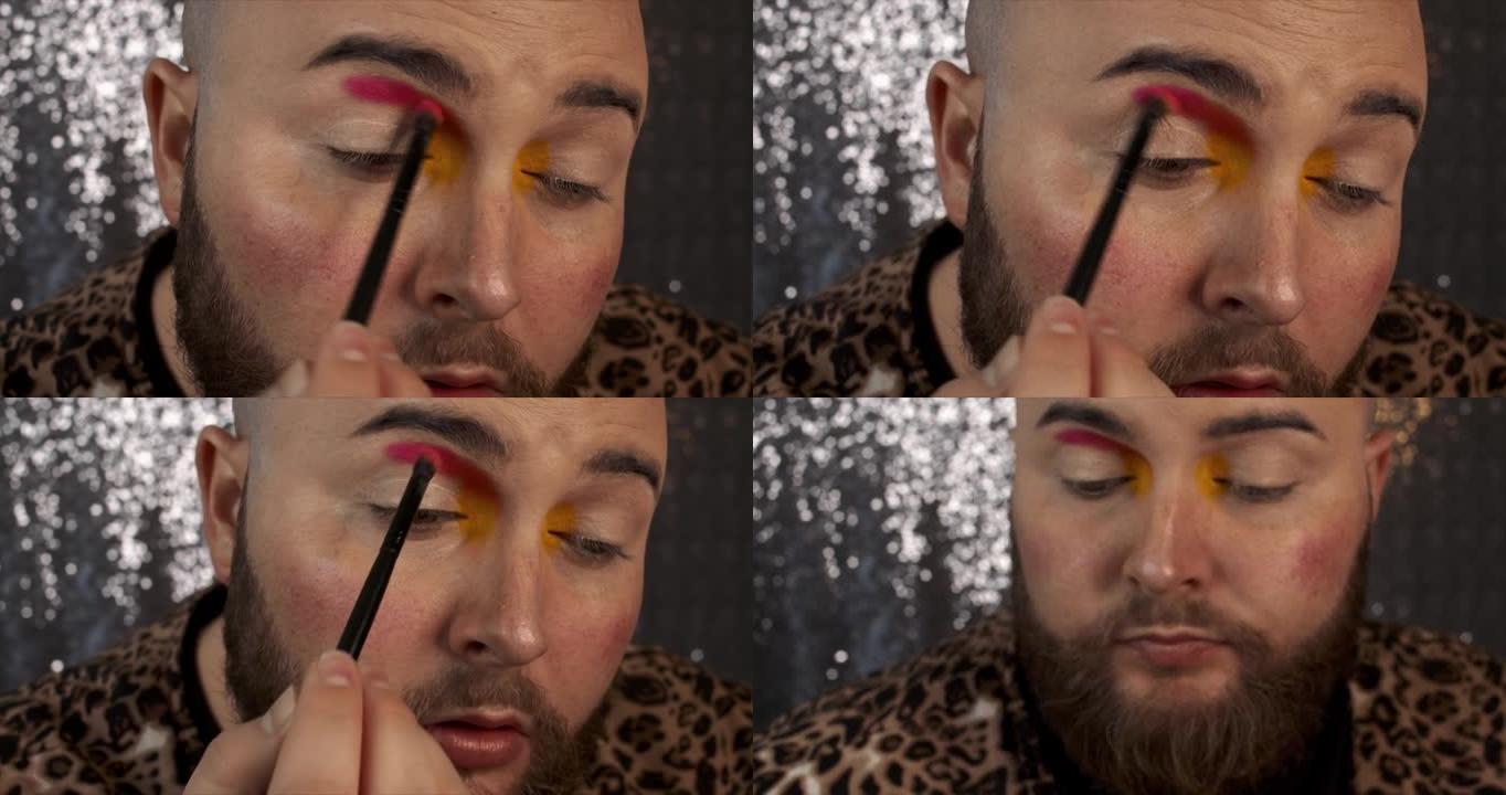 一名男性化妆师在眼睑上涂抹和混合亮粉色眼影的4k视频片段