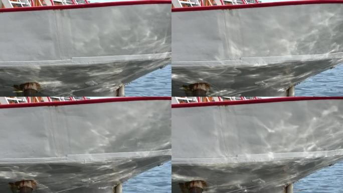 船前部的特写视图，水的腐蚀性阳光反射