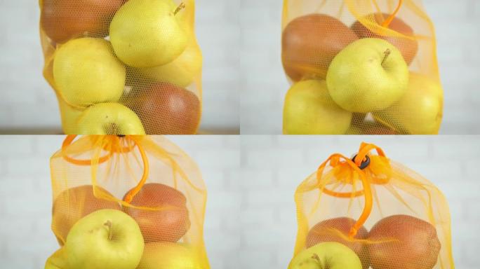五颜六色的苹果装在袋子里。