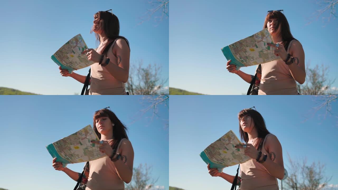 一个白人妇女的肖像站在路边，看着一张纸质地图。底视图。本地旅行和搭便车的概念