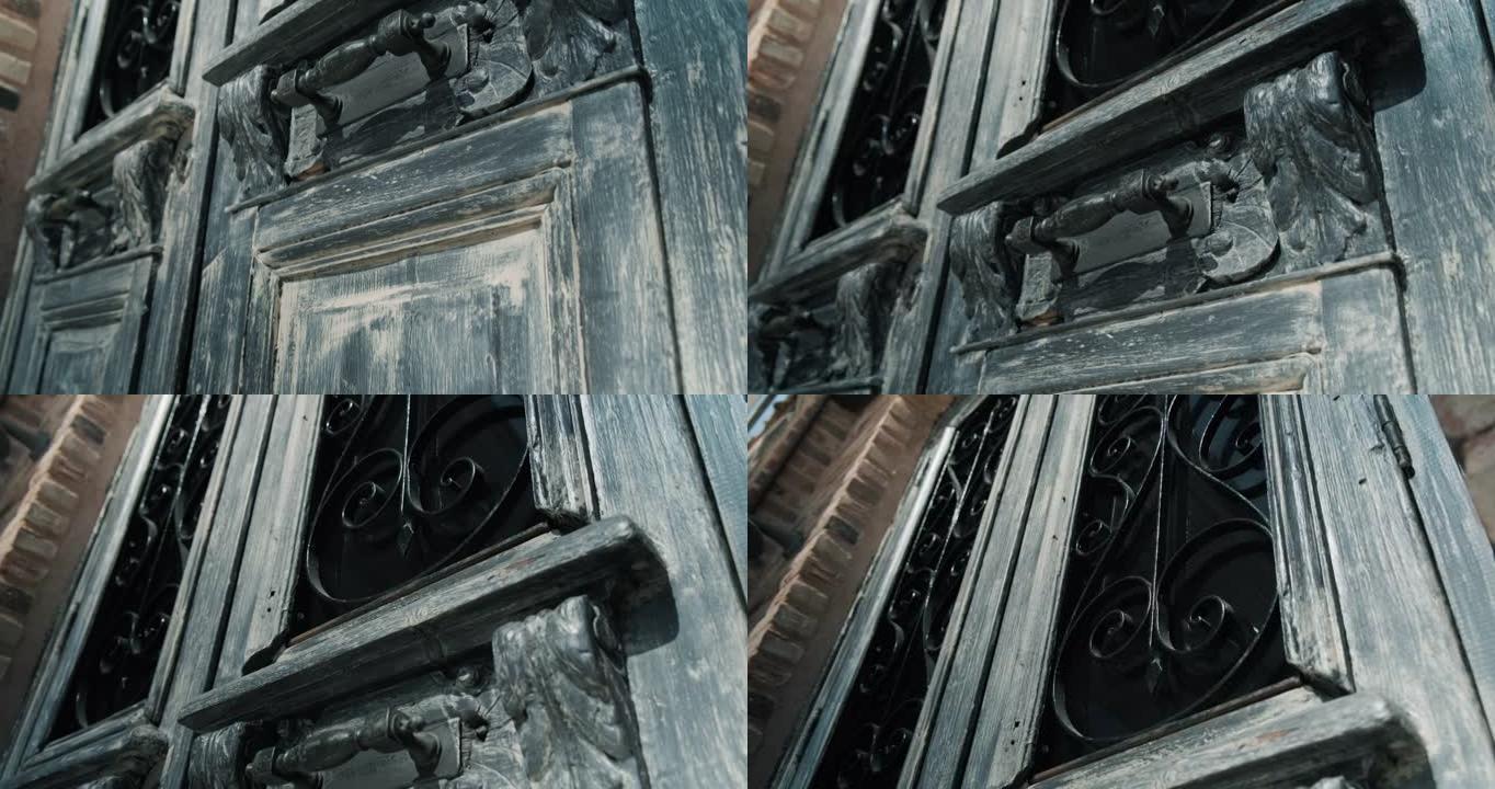 老式生锈木门的倾斜镜头，带铁把手。