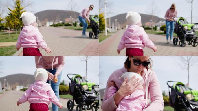 一个小孩去见他的母亲，母亲正站在婴儿车附近，在她的怀里遇见他。实时。相机在孩子后面的移动