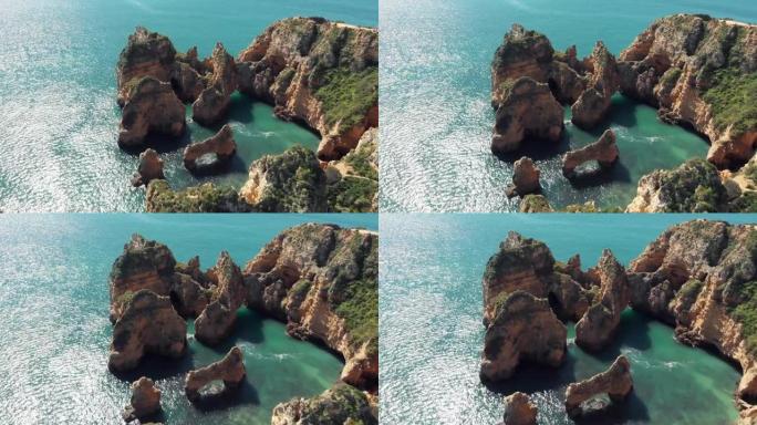 葡萄牙拉各斯阿尔加维蓬塔达皮达德岩石地层围护的俯视图-空中下降飞越射击