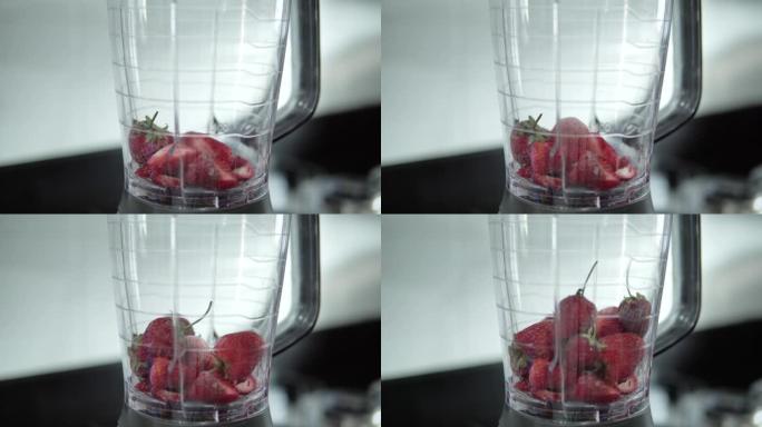 草莓冰沙配料在搅拌机中混合。