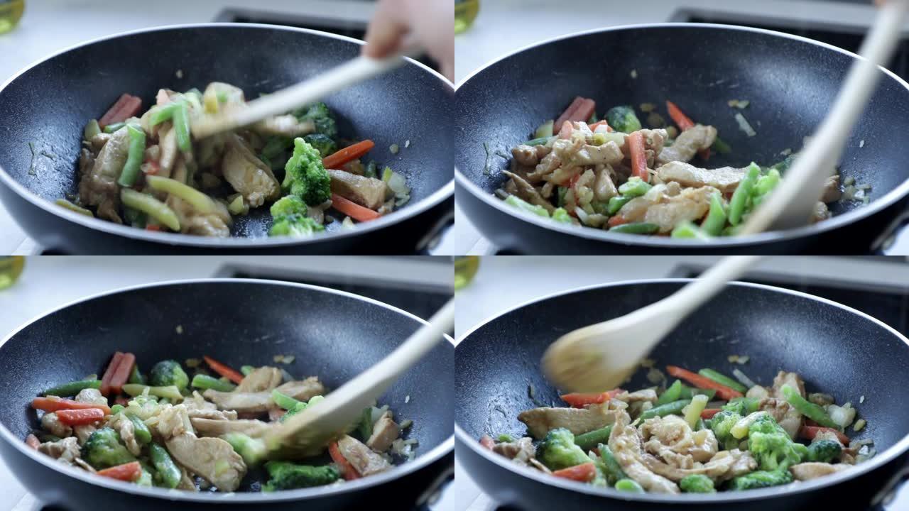 鸡肉在平底锅里炒，用木勺烹饪，亚洲食物