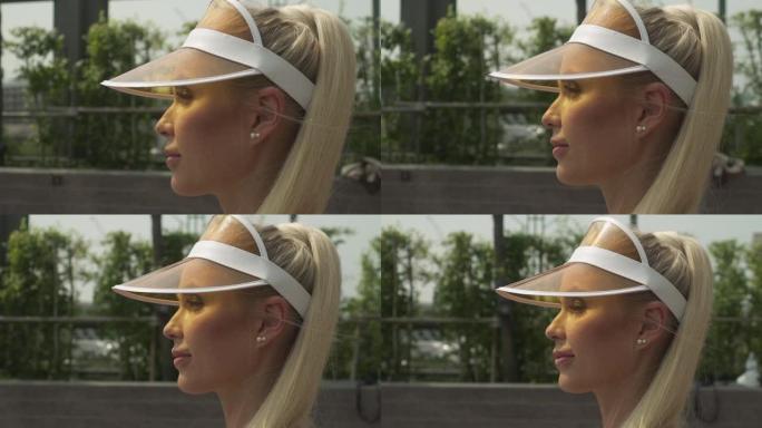 金发女网球运动员在阳光下的侧视图特写镜头
