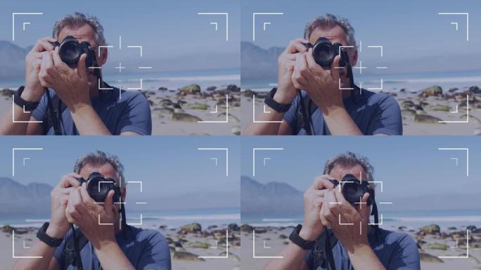 相机用户界面框架和聚焦屏幕在海边的高加索高级男子拍照