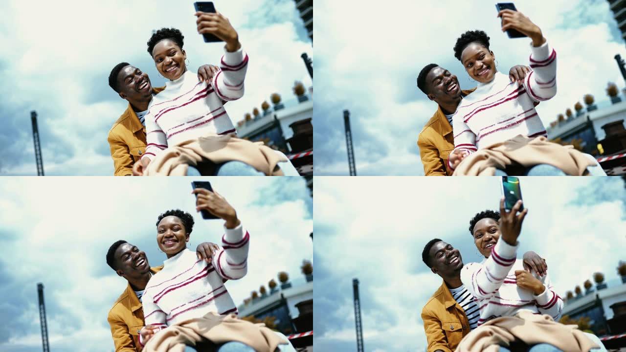 年轻的美国黑人夫妇享受阳光明媚的日子，自拍。