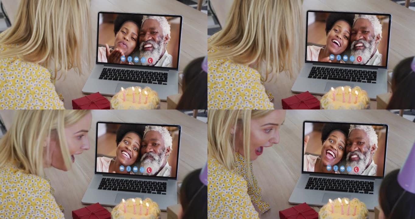高加索母亲和女儿在家里用笔记本电脑进行视频通话时庆祝生日