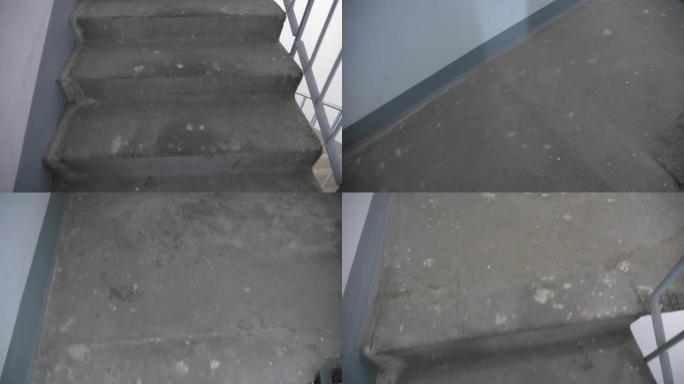 男人的概念爬上住宅楼的楼梯，评估困难。走上大楼内的楼梯。相机移动和选择性对焦。