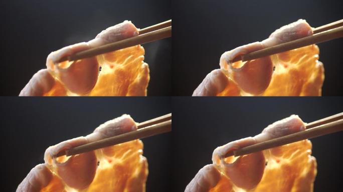 在用筷子搅拌的煮汤火锅中蘸切成薄片的优质猪肉的ECU慢动作镜头