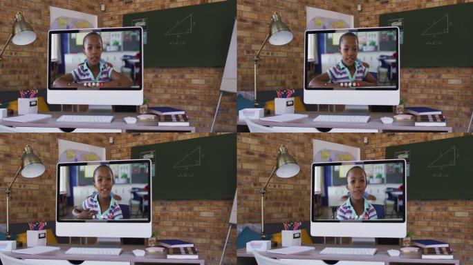 非裔美国女学生的网络摄像头视图在学校桌子上的电脑上进行视频通话