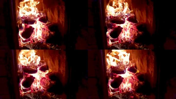炽热的火焰加热旧壁炉燃烧木头原木，黑暗黄昏煤灰煤渣中的纸质信件。浪漫的壁炉。在家里壁炉里燃烧的热火焰