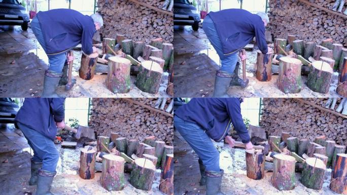 一位老人将一块楔子放在原木上，并用一把大锤将其砸碎