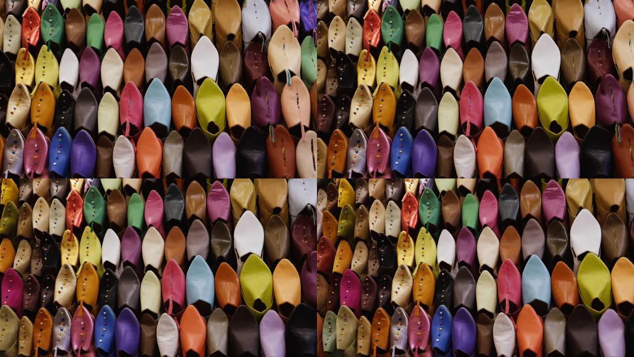 摩洛哥马拉喀什 (马拉喀什) 麦地那的墙上陈列着正宗的彩色摩洛哥拖鞋 (babouches)。