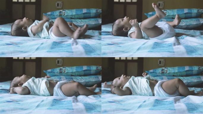 新生男婴用手臂胸部和背部肌肉踢和向后移动抬起头和胸部。四个月大的可爱的幼儿。印度种族。儿童保健背景。