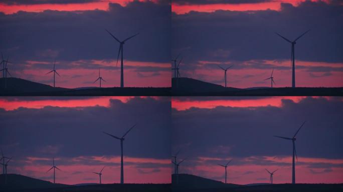 西班牙安达卢西亚日落时山丘上的风力涡轮机