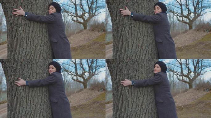 女人拥抱公园里的树