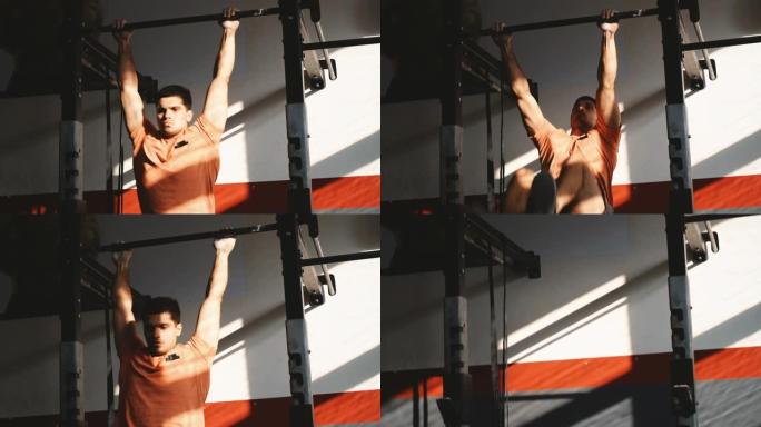 运动男子在健身房的单杠上锻炼