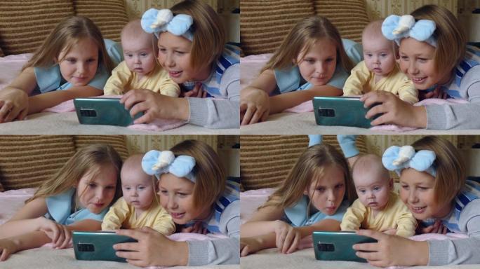 儿童向婴儿展示智能手机上的视频