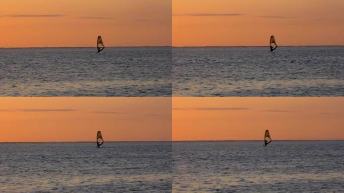 男子在留尼汪岛日落时滑浪风帆