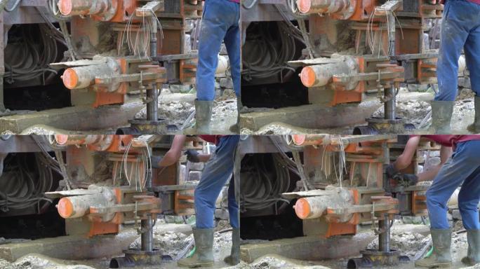 工人和机器在建筑工地上用缠绕钻钻水井
