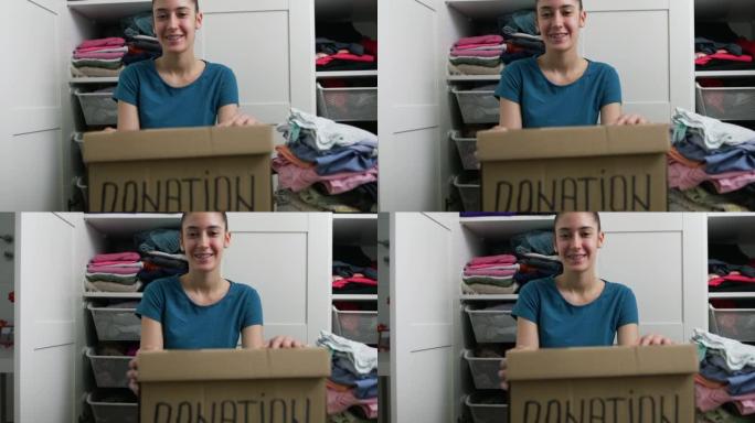 年轻女子整理衣服捐赠