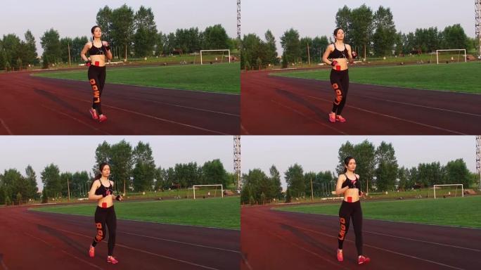 俄罗斯克麦罗沃-2018年7月11日: 慢动作。年轻的女运动员在户外跑步机上在体育场跑步